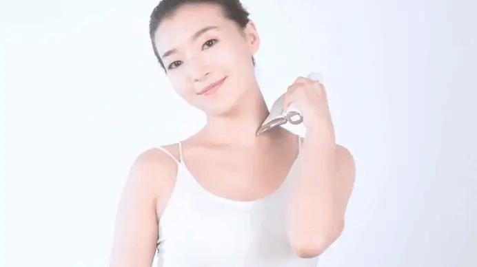 Electric Gua Sha Massager used on arm with curved design for smooth skin scraping and muscle relaxation