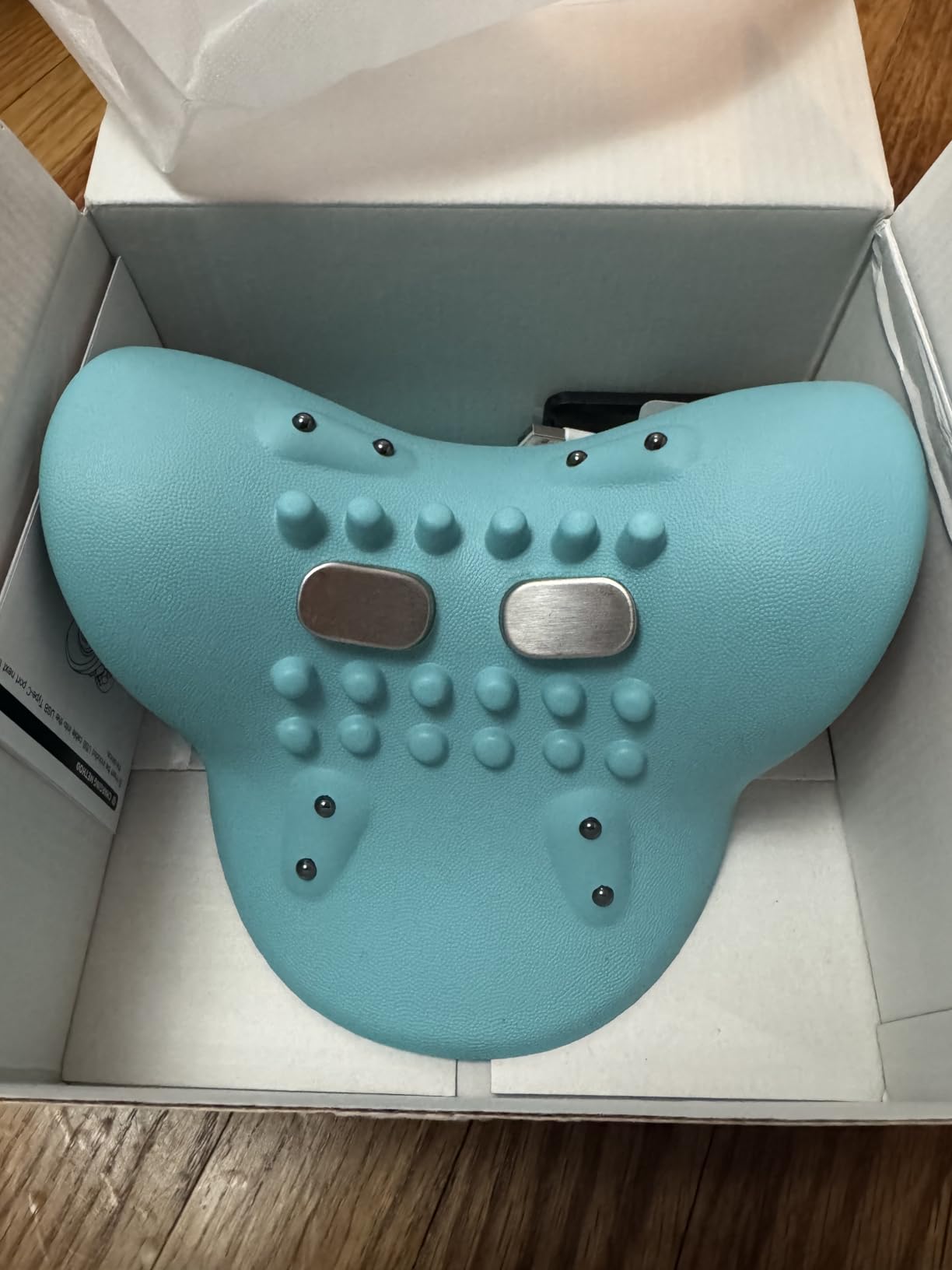 Blue electronic device with buttons and a screen in an open box.
