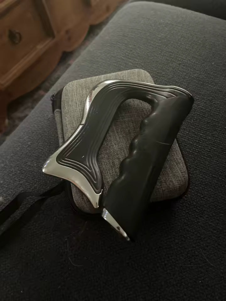 Black and silver belt buckle on a gray cushion
